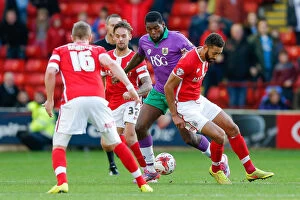 Images Dated 25th October 2014: Jay Emmanuel-Thomas vs Lewin Nyatanga: Intense Moment in Barnsley vs Bristol City Football Match