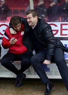 Images Dated 18th January 2014: Karl Robinson Shares a Light-Hearted Moment with MK Dons Bench Before Bristol City Clash