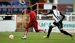 Friendly Prints: Kieran Agard Surges Past Bath City's Manny Monthe in Pre-Season Friendly