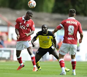 Bristol City V Colchester United Prints: Mark Little Wins Aerial Battle Against Jabo Ibehre in Bristol City vs Colchester United Football Match