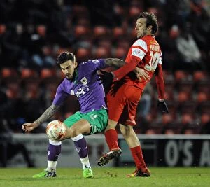 Images Dated 3rd March 2015: Maron Pack vs. Gianvito Plasmati: Intense Battle for the Ball in Leyton Orient vs