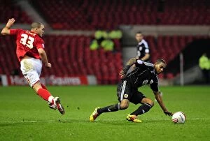 Images Dated 25th January 2011: Marvin Elliott Tackles Joel Lynch in Intense Forest vs. Bristol City Championship Clash