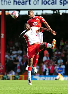 Bristol City V Nottingham Forest Prints: Marvin Elliott vs. Guy Moussi: Aerial Clash in the Championship Showdown between Bristol City and Nottingham Forest