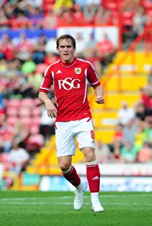 Season 11-12 Prints: Neil Kilkenny of Bristol City Faces Off Against West Brom in Championship Clash at Ashton Gate