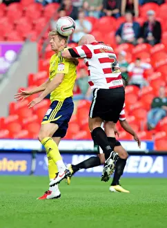 Framed Print : Nicky Maynard Flicks Ahead of James O'Connor in Doncaster Rovers vs. Bristol City League Cup Clash - 27 / 08 / 2011