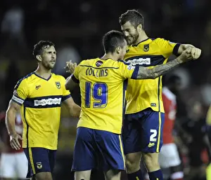 Capital One Prints: Oxford United's Upset Victory: Jonathan Meades and Michael Collins Celebrate Overpowering Bristol City