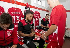 Bristol City V Wigan Athletic Prints: Scott Golbourne of Bristol City Signs Autograph for Mascot in Changing Room during Bristol City v Wigan Athletic Match