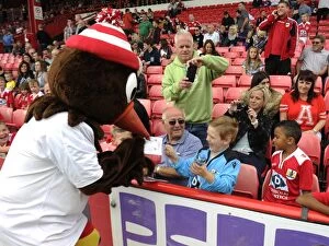 Images Dated 13th September 2014: Scrumpy the Mascot Delights Fans at Bristol City vs Doncaster Rovers Match, Ashton Gate