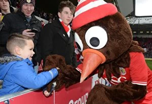 Images Dated 5th March 2016: Scrumpy and the Young Bristol City Fan: A Moment of Passion at Ashton Gate