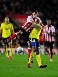 Images Dated 30th December 2011: Southampton's Morgan Schneiderlin Fouls Marvin Elliott in Championship Clash between Southampton