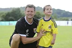 Steve Cotterill and Young Fan Share a Moment at Portishead Town's The Playing Fields During Pre-Season Friendly