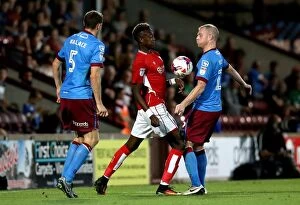 Images Dated 23rd August 2016: Tammy Abraham vs Neil Bishop: Intense Battle for the Ball at Glanford Park