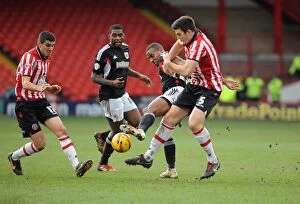 Images Dated 22nd February 2014: Tyrone Barnett vs. Harry Maguire: Intense Battle for the Ball in Sheffield United vs
