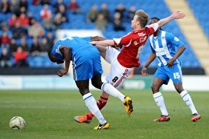 Images Dated 22nd March 2014: Wade Elliott vs Magnus Okuonghae: Intense Battle for the Ball in Colchester United vs Bristol City