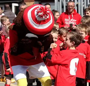 Bristol City V Coventry City (Champions) Prints: Young Fan Playfully Fights with Bristol City's Robin Mascot during Sky Bet League One Match against Coventry City